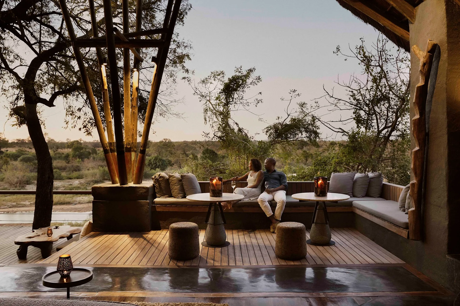 Couple enjoying an exclusive sundowner on a private safari lodge terrace in Africa