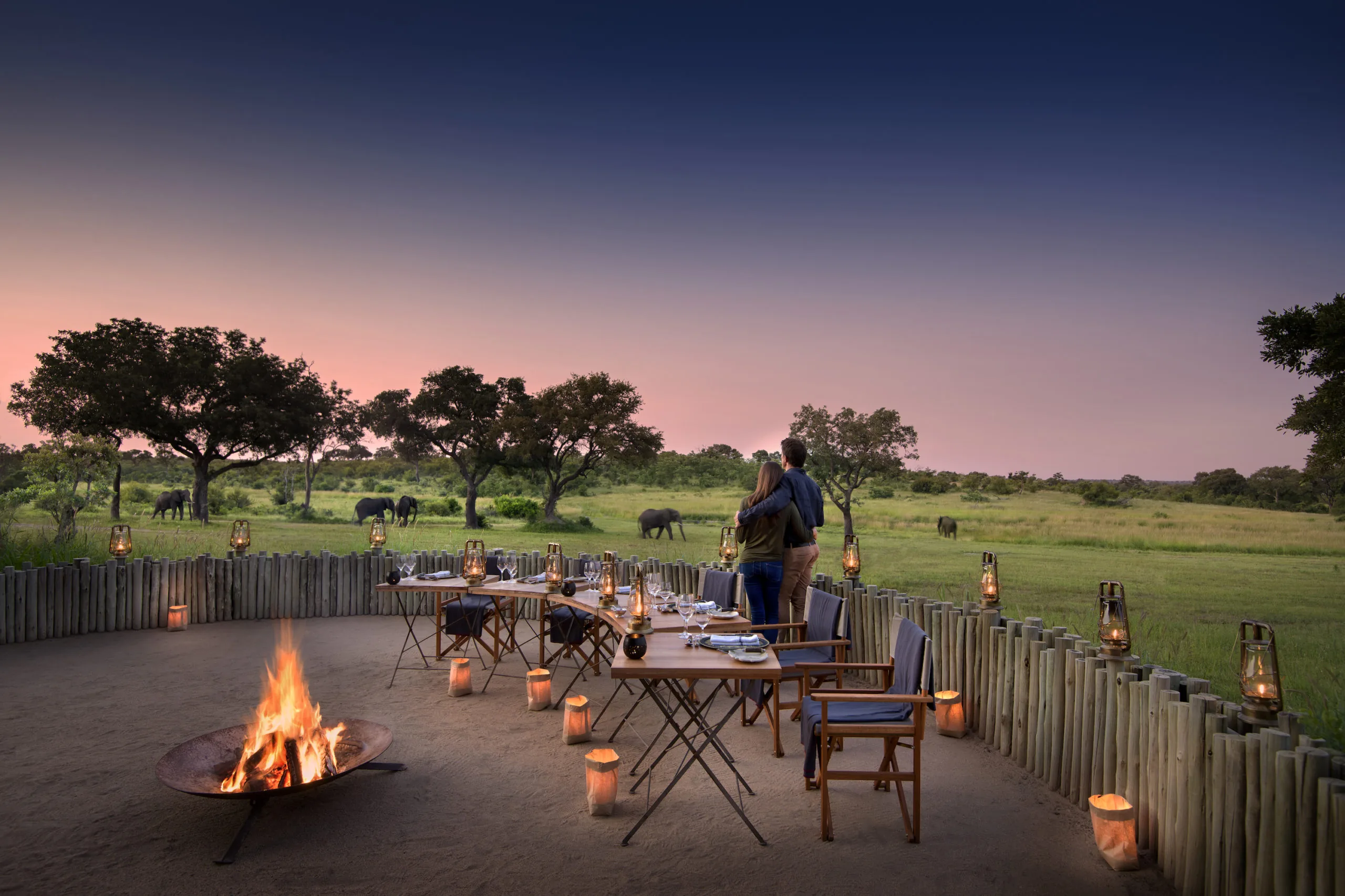 Couple enjoying an exclusive sundowner on a private safari lodge terrace in Africa