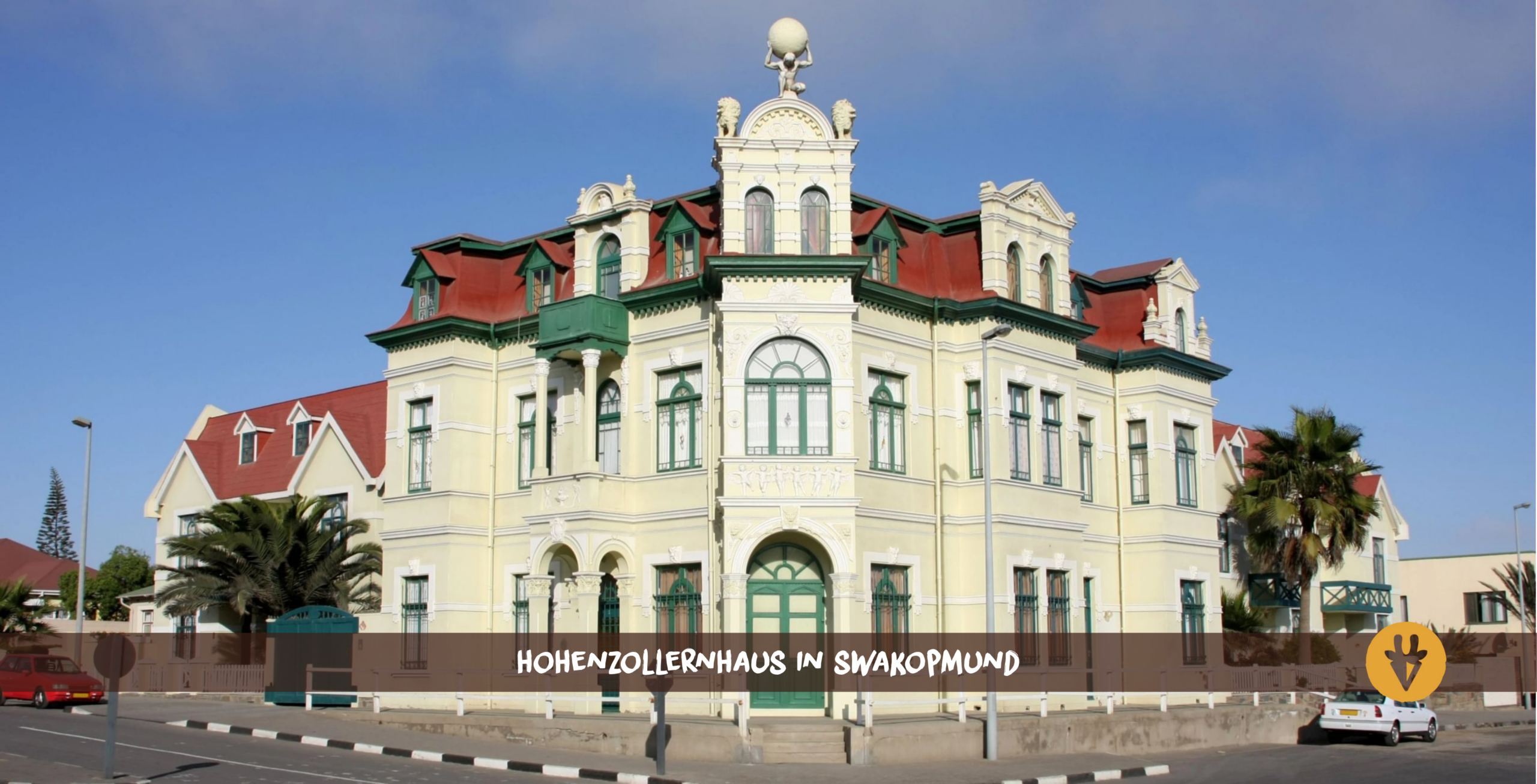 Swakopmund Hohenzollernhaus at the corner with two cars in front