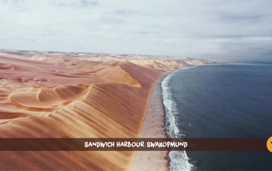 Sand dunes and the ocean at Sandwich Harbour in Namibia