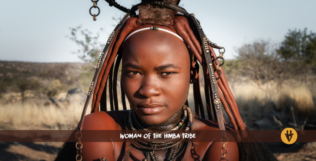 A Himba woman with ochre-red strands of hair and necklaces